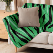Green tiger blanket vibrant green and black zebra-striped throw blanket draped over beige sofa for cozy use