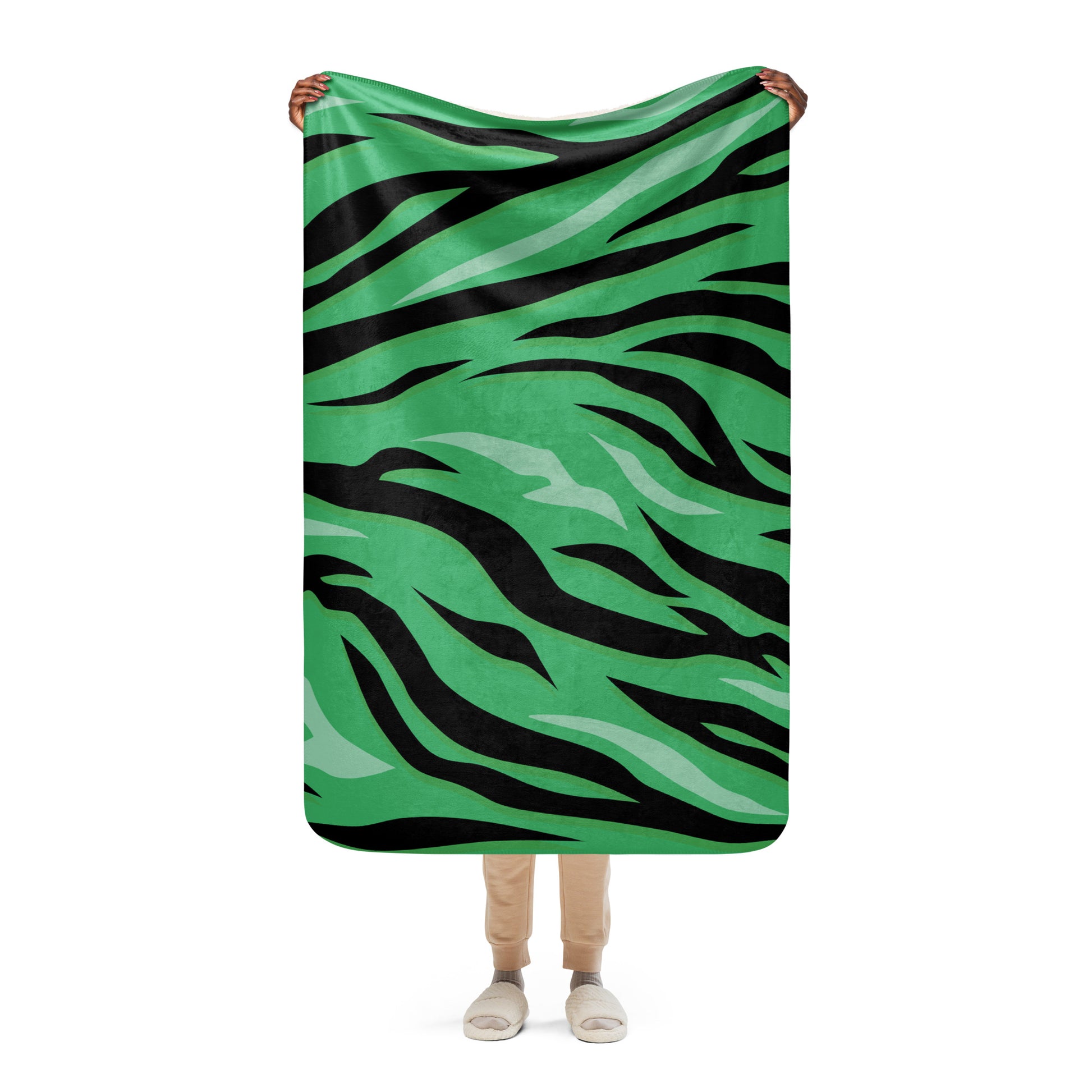 Green tiger blanket with green and black tiger stripe pattern made of soft fleece for cozy warmth and decor