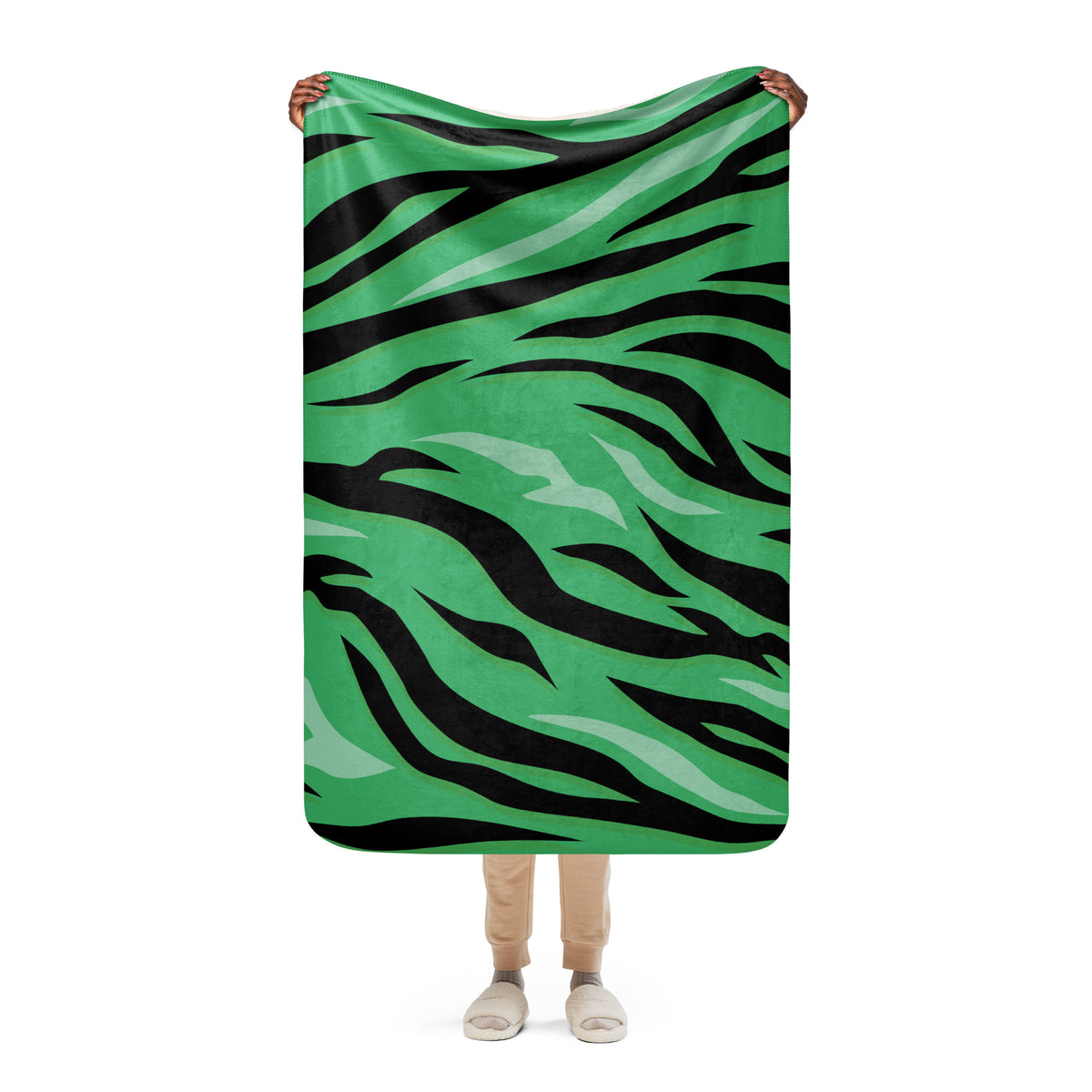 Green tiger blanket with green and black tiger stripe pattern made of soft fleece for cozy warmth and decor