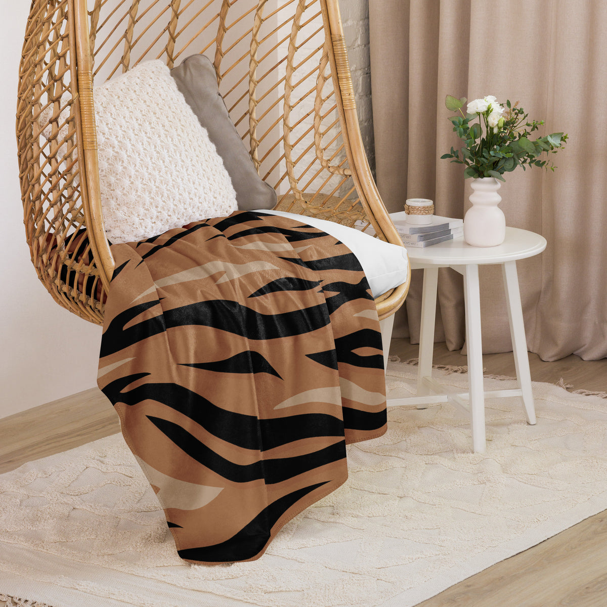 Brown tiger blanket tiger print throw blanket with bold black stripes on tan background draped over wicker hanging chair
