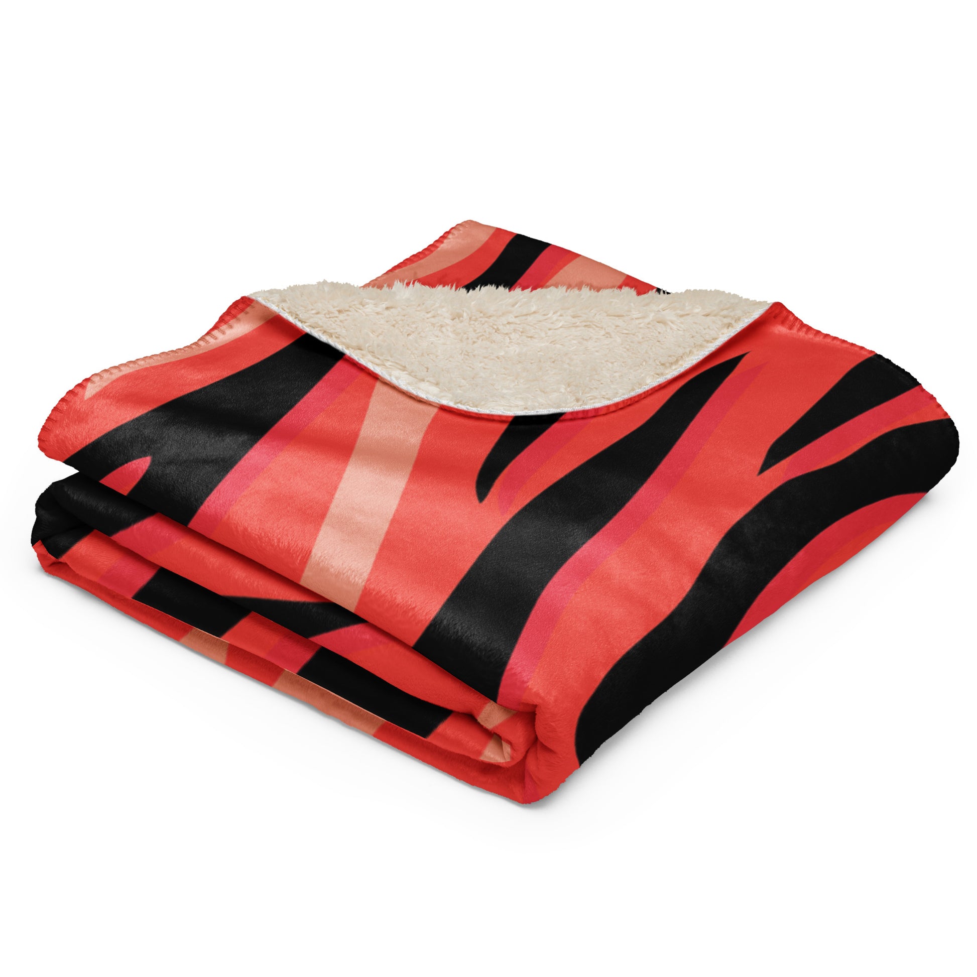 A cozy red tiger blanket with red and black fleece stripes and plush cream sherpa lining for warmth and comfort