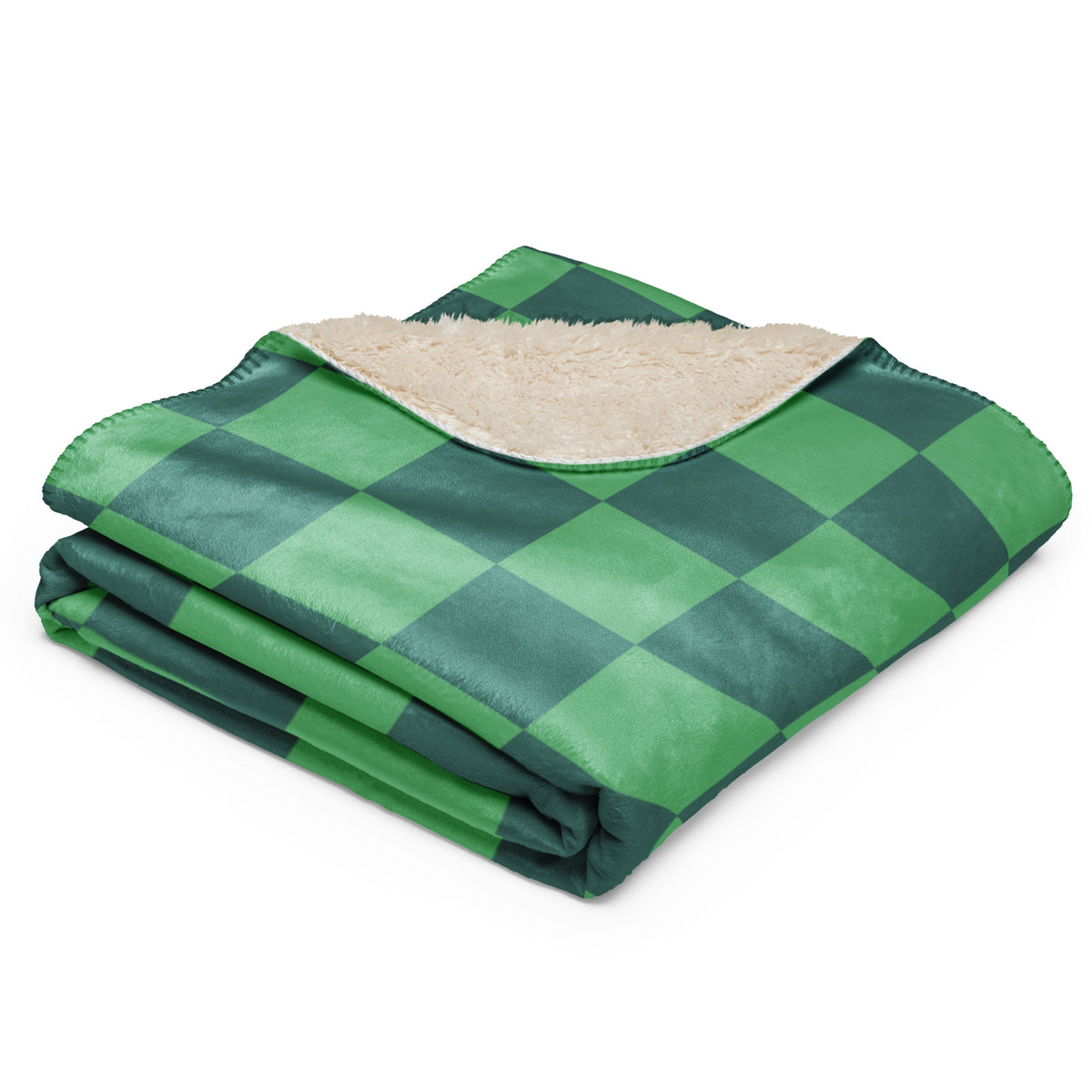 Folded green checkered blanket with dark green plaid and plush beige sherpa lining for cozy warmth