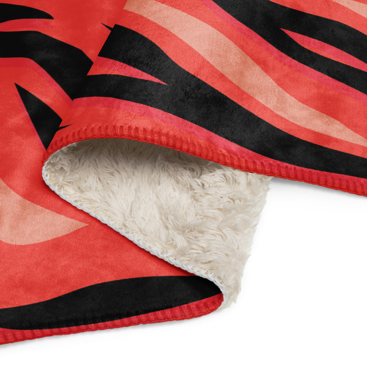 Red tiger blanket fleece with red and black zebra stripes and a plush white interior for cozy warmth