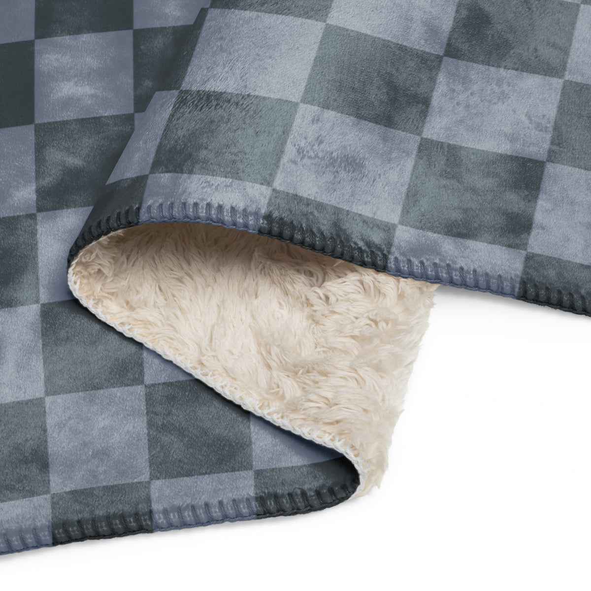 Grey checkered blanket with a gray and white fleece exterior and a plush cream-colored sherpa lining for warmth