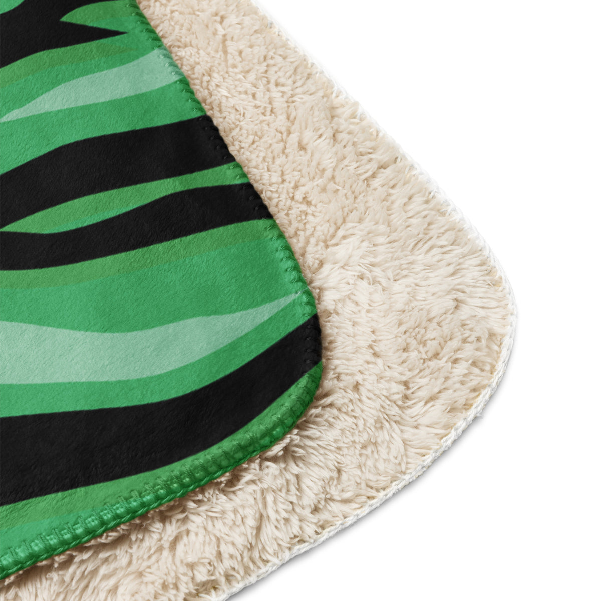 Green tiger blanket fleece with green and black zebra stripes and plush cream sherpa lining visible on back side