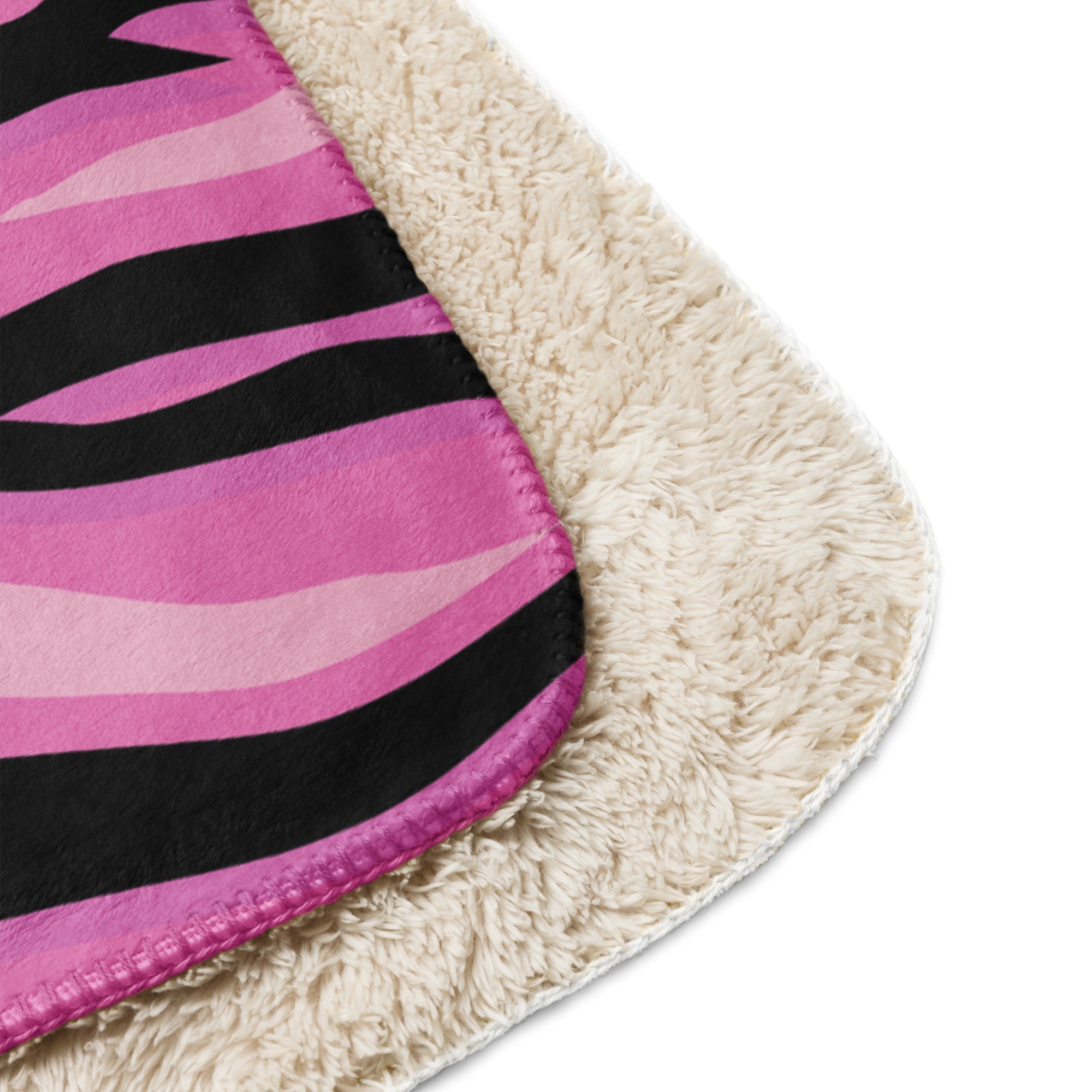 Pink tiger blanket fleece with pink and black zebra stripes and plush cream sherpa lining for cozy warmth