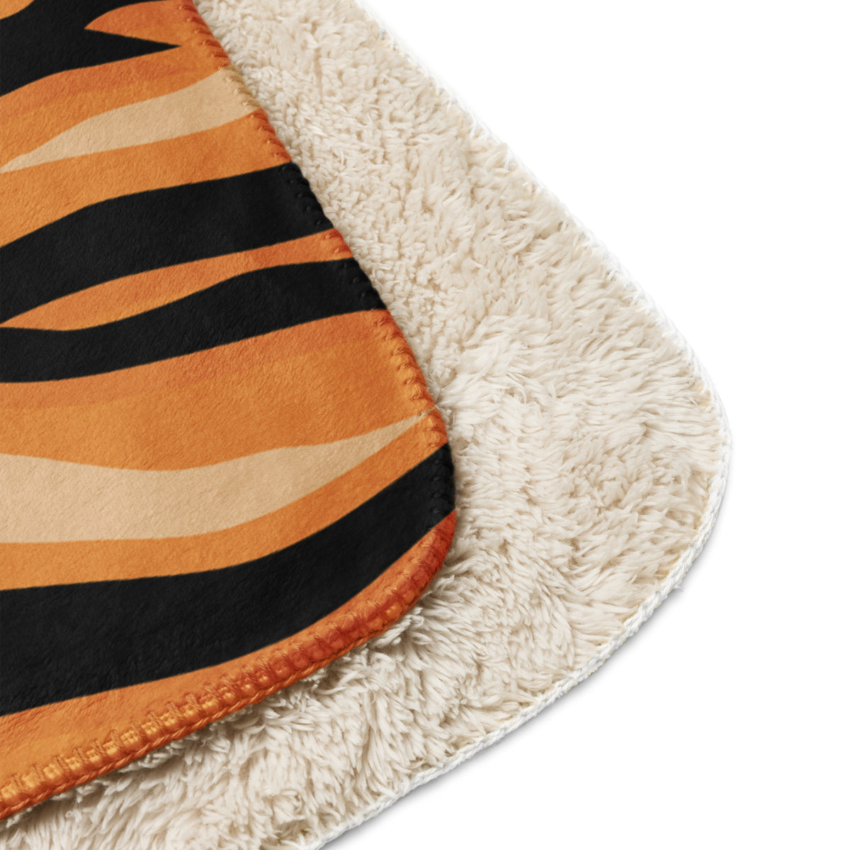 Orange tiger blanket fleece with orange and black tiger stripes and plush cream sherpa lining for warmth and comfort