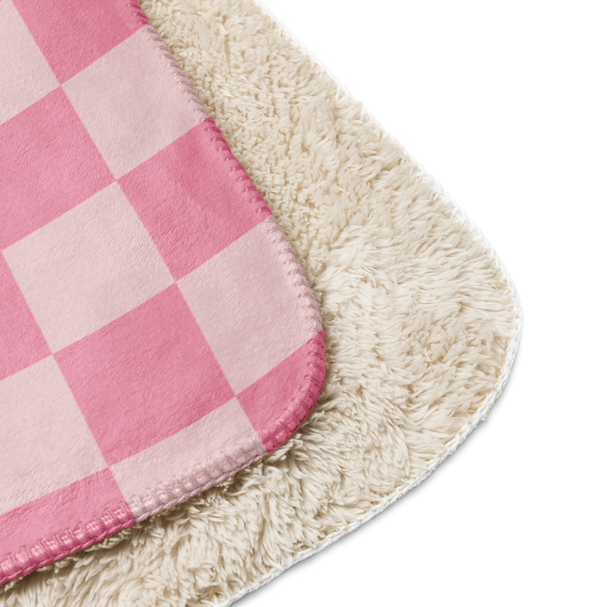 Pink checkered blanket with plush cream-colored sherpa lining for cozy warmth and softness