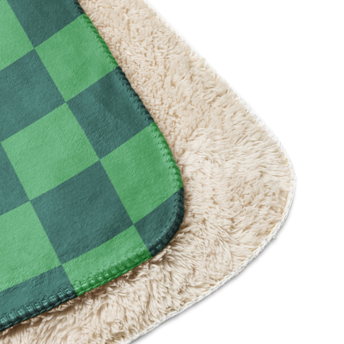 Green checkered blanket with green and dark green plaid exterior and plush cream sherpa lining for warmth
