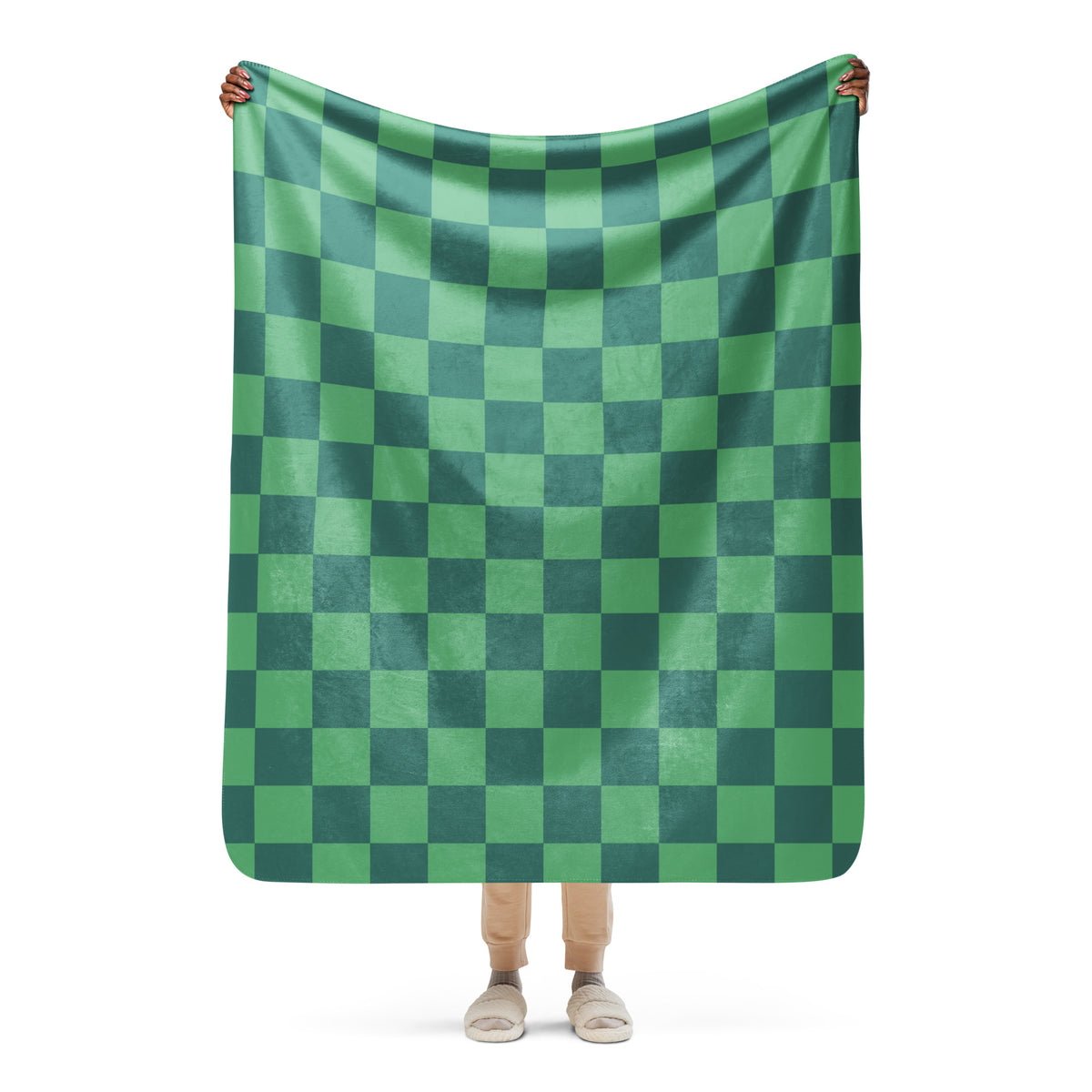 A soft plush green checkered blanket with bold green and dark green checkerboard pattern for cozy use