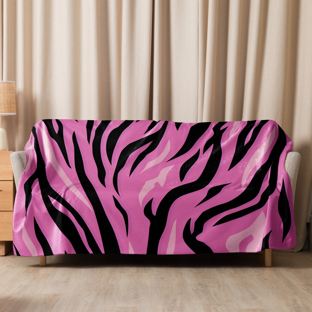 A vibrant pink and black zebra-striped sofa cover with a glossy fabric finish called pink tiger blanket