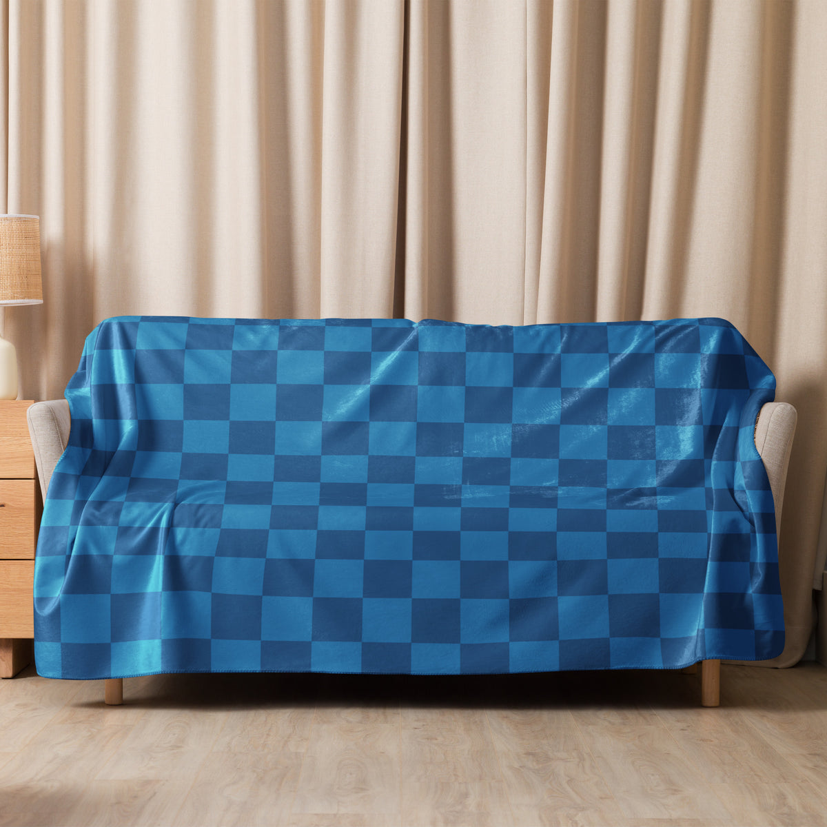 Blue checkered sofa cover with glossy slightly reflective fabric for stylish home decor and protection