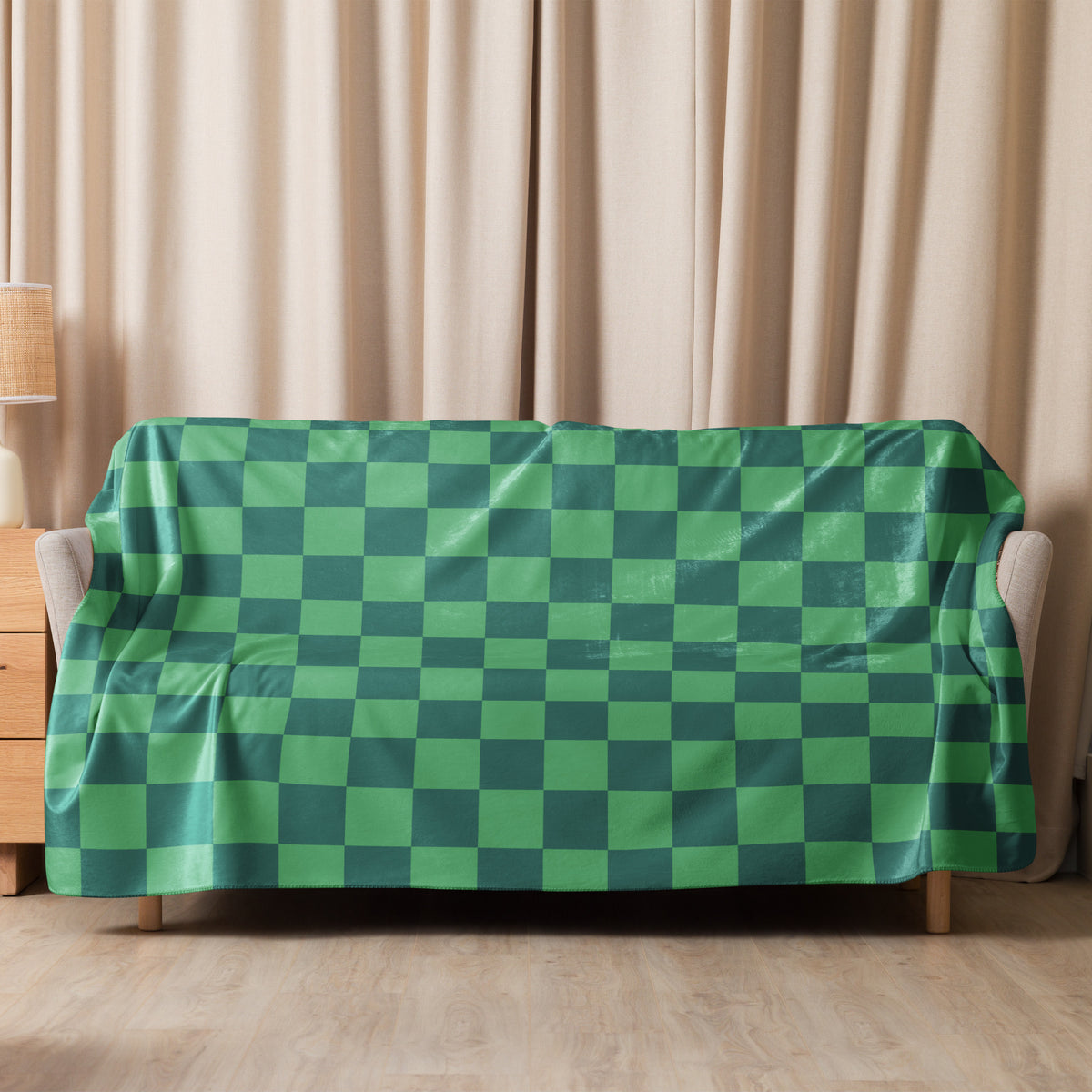 Green checkered blanket with a glossy slightly reflective surface used as a sofa cover