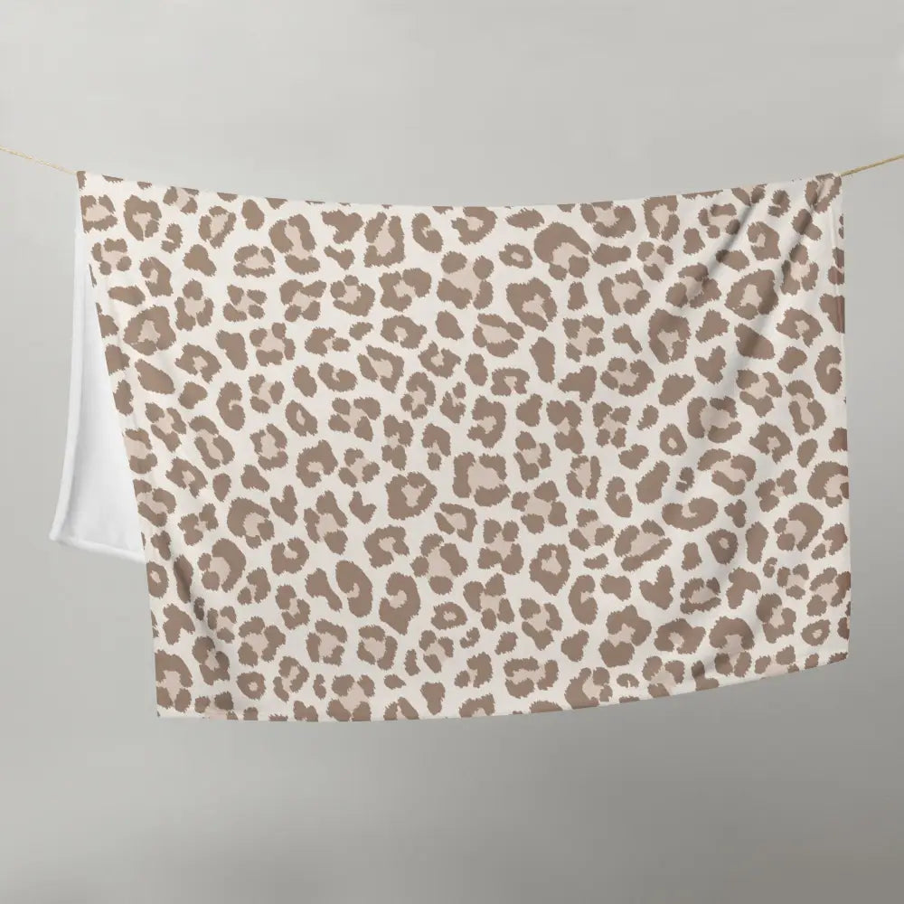 Tan leopard print blanket with plush texture in soft beige and taupe leopard pattern