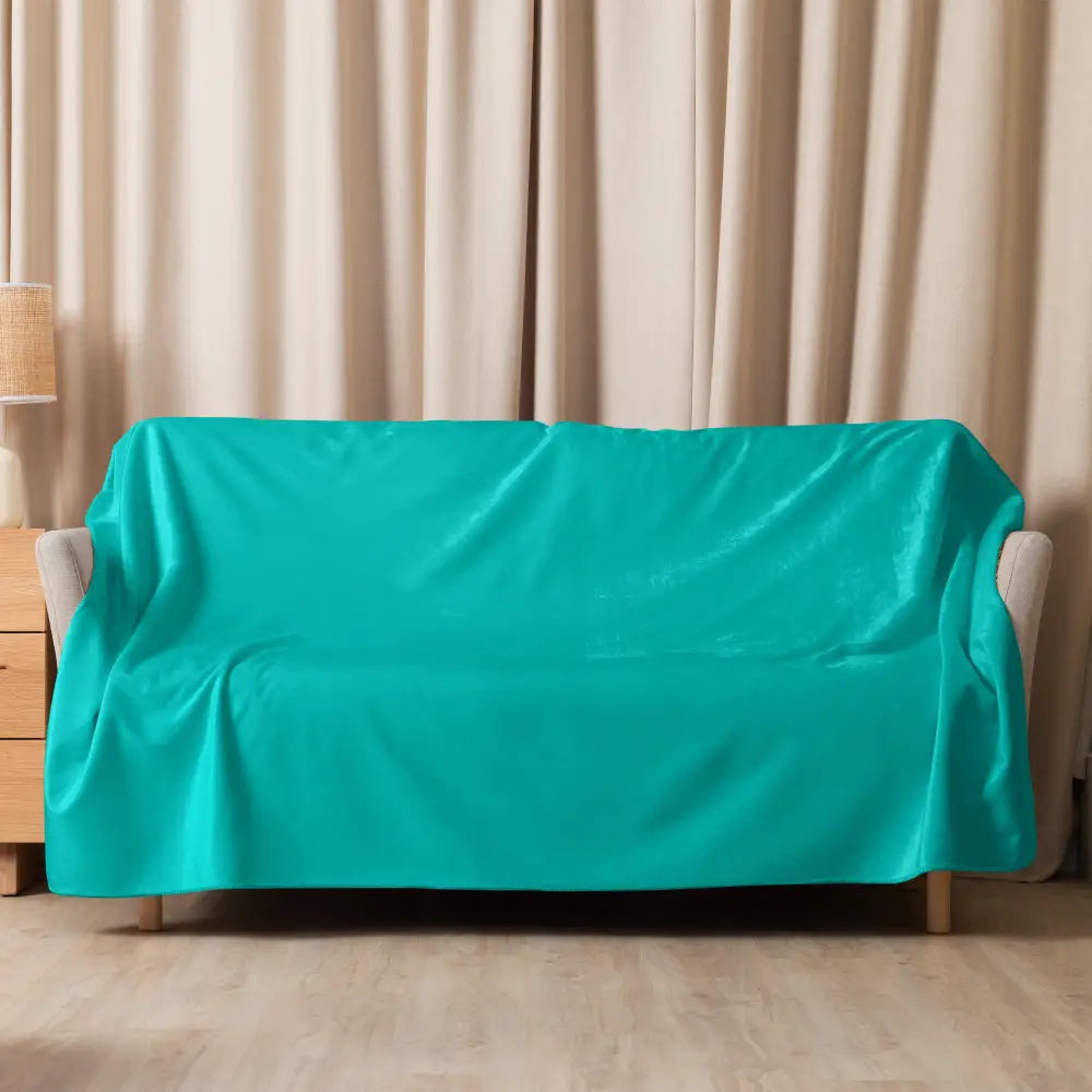 Teal velvet sofa cover shown with turquoise sherpa blanket highlighting soft material and cozy use-case