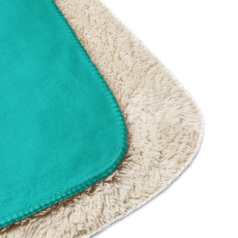 Turquoise sherpa blanket bath mat with cream accents featuring a soft fuzzy plush texture for bathroom use