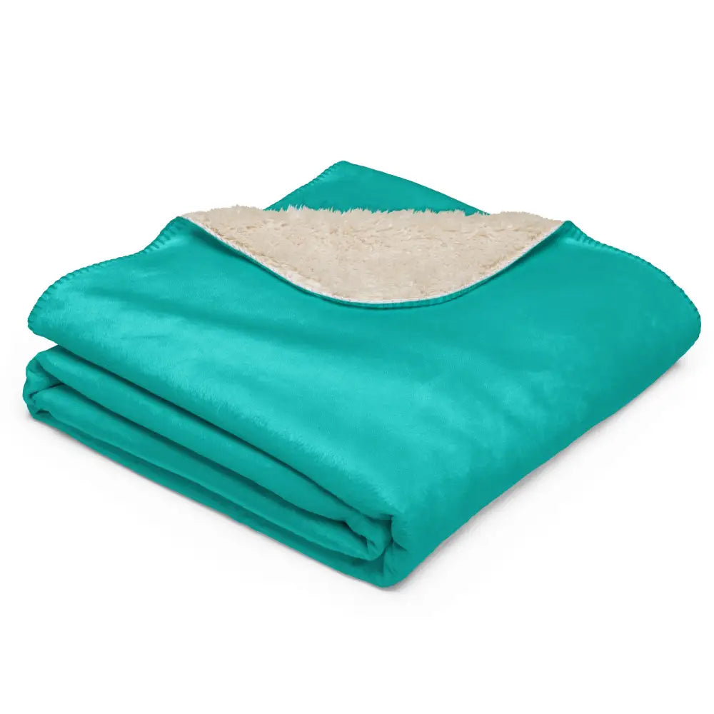 Turquoise sherpa blanket with teal fleece exterior and plush cream-colored sherpa lining for warmth and comfort