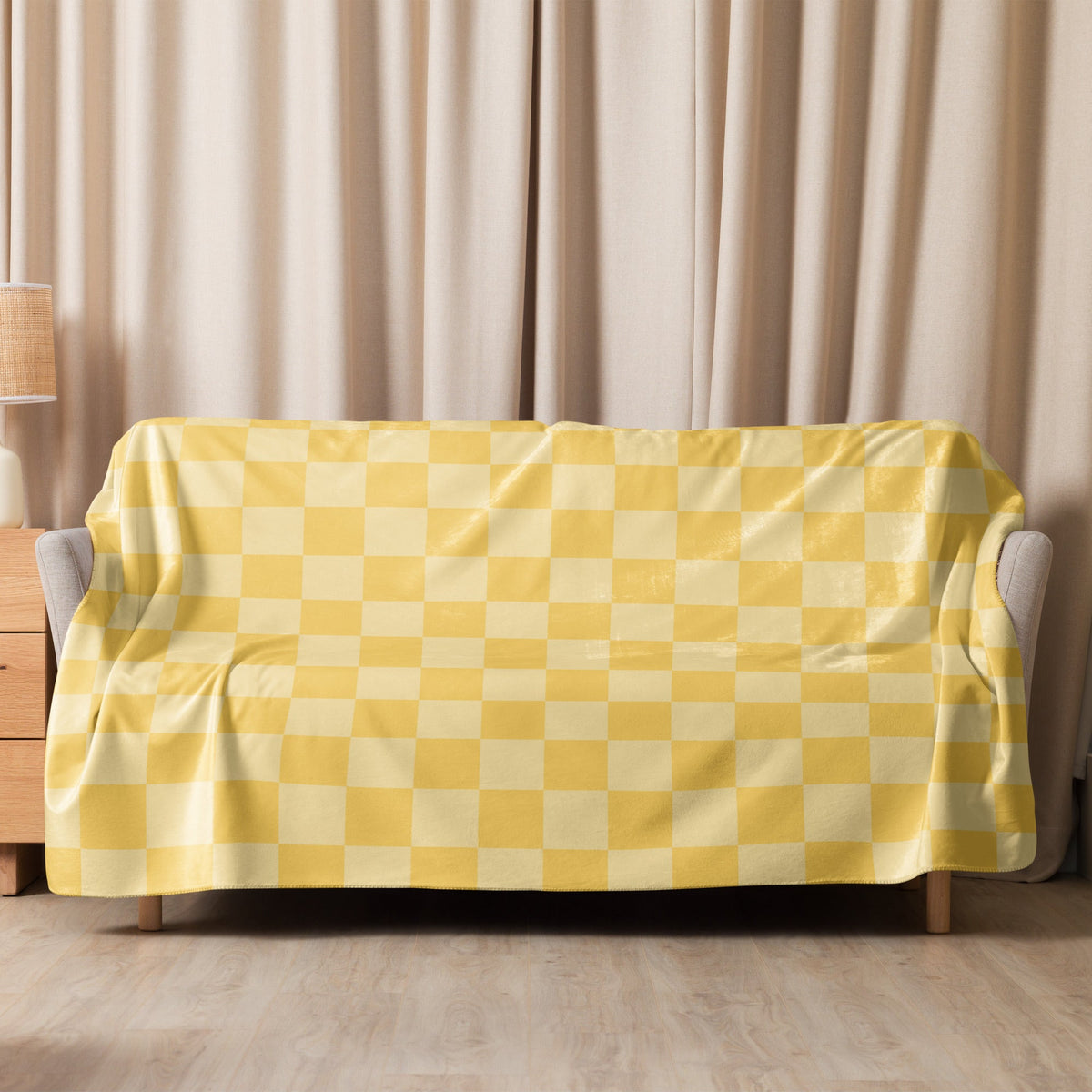 Yellow checkered blanket in yellow and cream draped over a sofa showcasing its soft woven material and cozy design