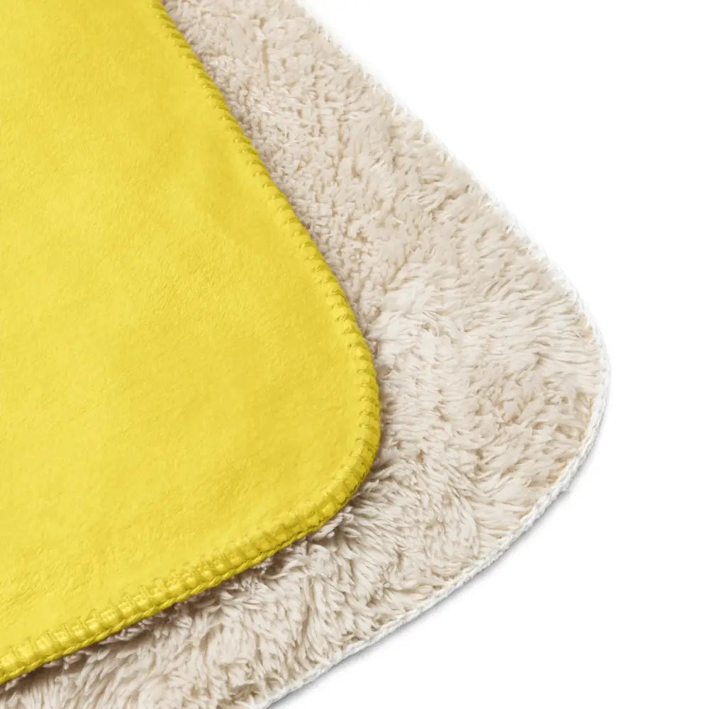 Bright yellow sherpa throw blanket with soft plush surface and cream-colored sherpa lining for cozy warmth